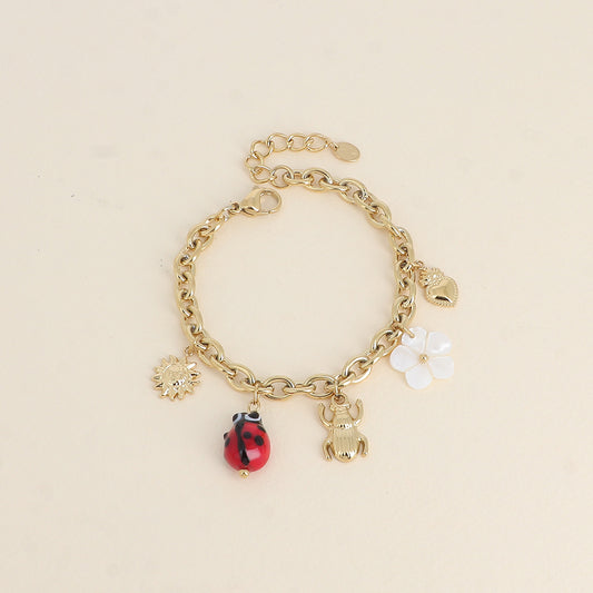 Bracelet - pendentifs (soleil, coccinelle en céramique émaillée, scarabée, fleur nacrée, cœur)